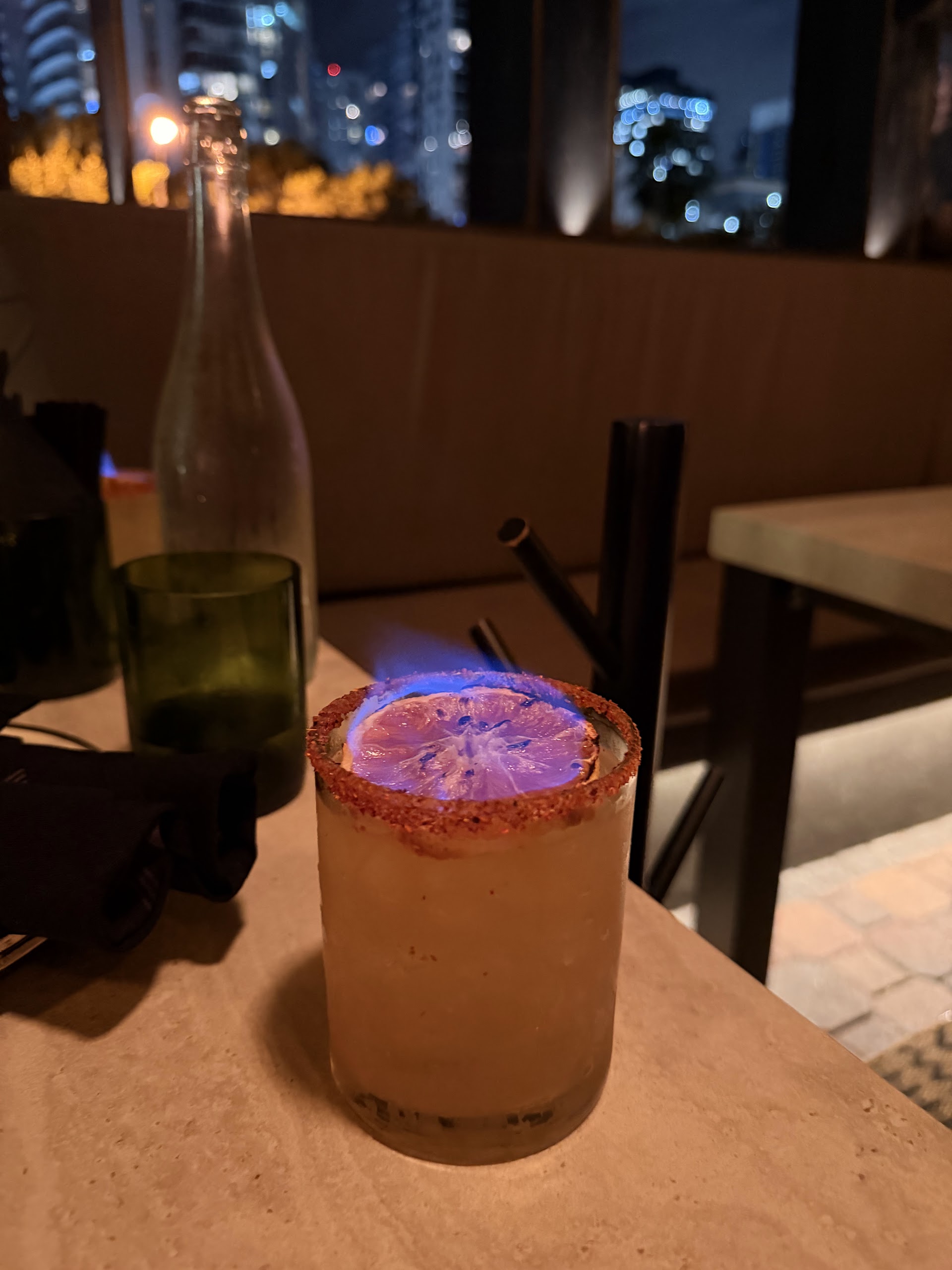 Citrus cocktail with ice — warm bar lighting