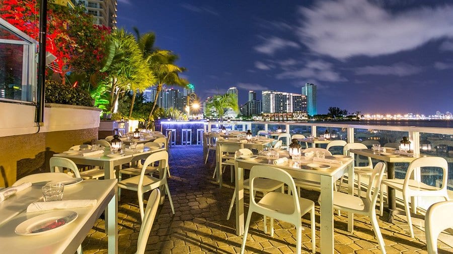 Outdoor deck overlooking Biscayne Bay at golden hour — Crazy About You, Brickell
