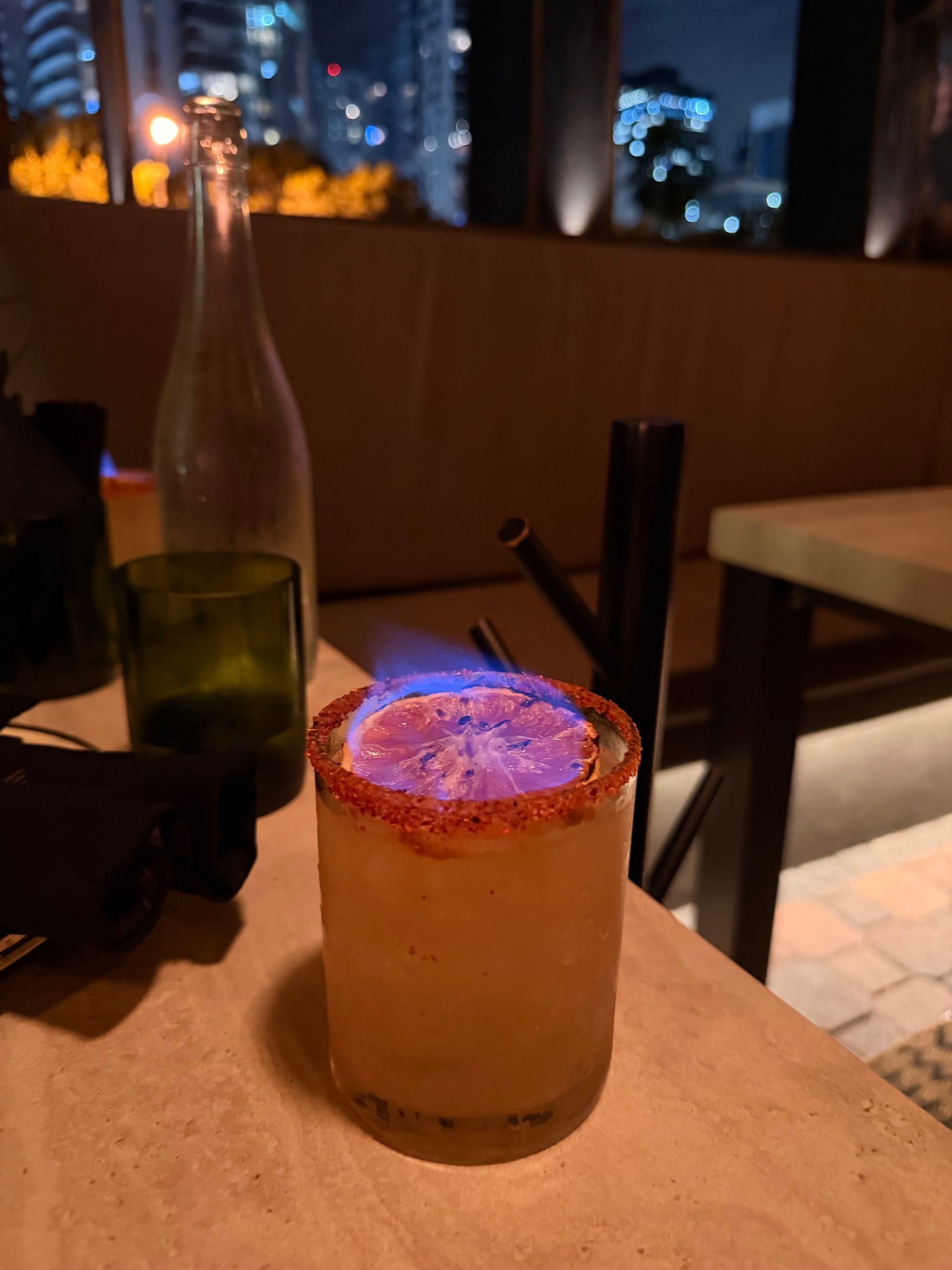 Flaming cocktail with citrus garnish